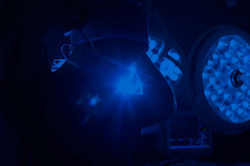 Surgeon putting on mask in operating room