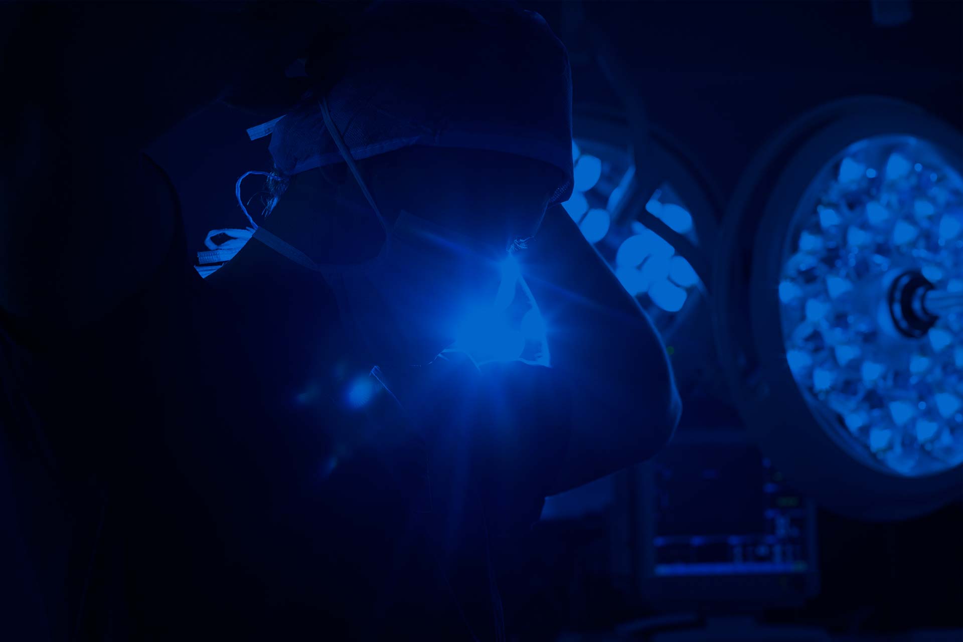 Surgeon putting on mask in operating room